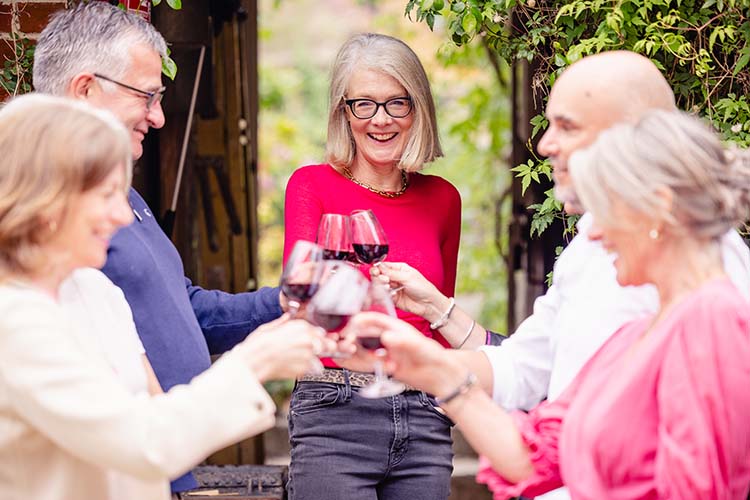 a group of giggling grape clients at a wine tasting event