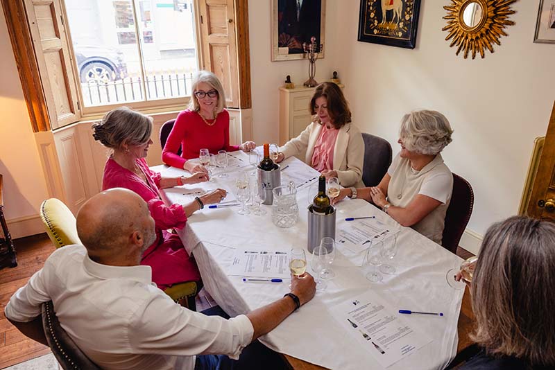 wine lovers enjoying their wine and study with giggling grape